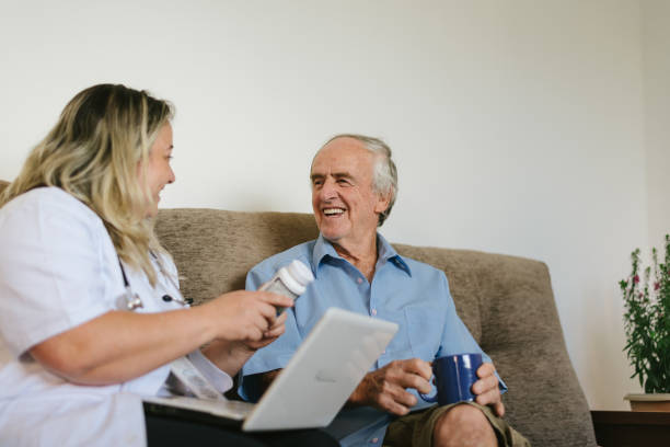 istock Nurse talking to elderly man at home 1248323528