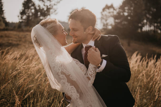 istock Very beautiful bride and groom having romantic time while wind blows wheats in the forest. 1248326582