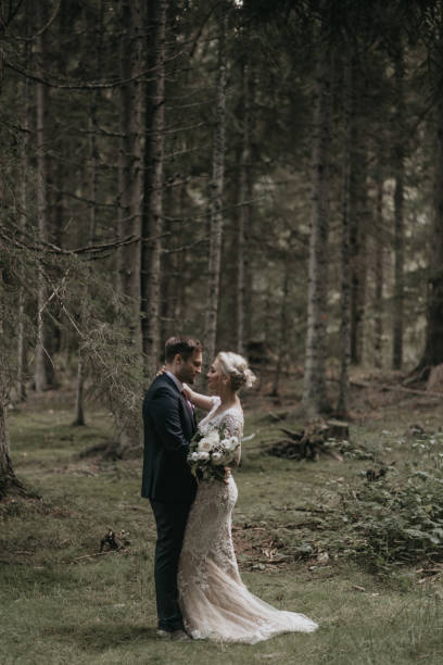 istock Very beautiful bride and groom having romantic time while wind blows wheats in the forest. 1248327244