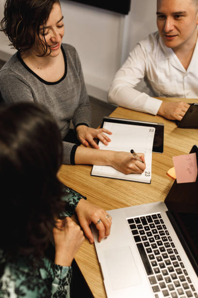 istock High angle view of office colleagues working by the table 1248327353