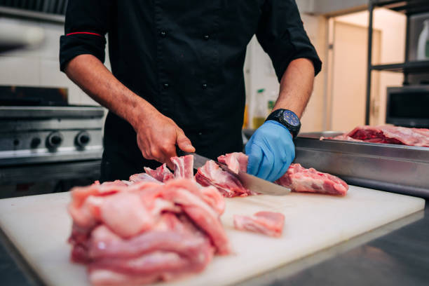 istock Male chef cutting raw pork ribs 1248327561