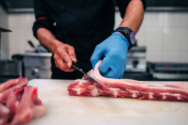 istock Male chef cutting raw pork ribs 1248327562