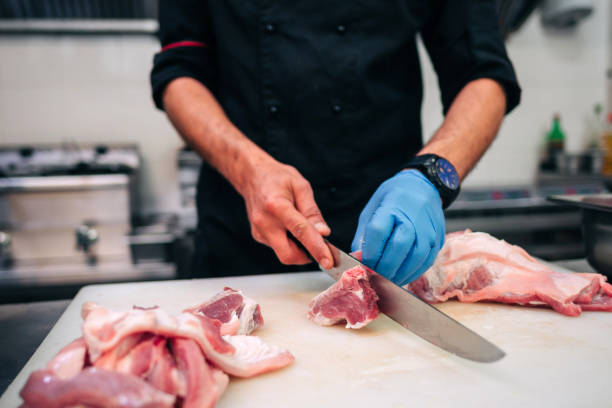 istock Male chef cutting raw pork ribs 1248327564