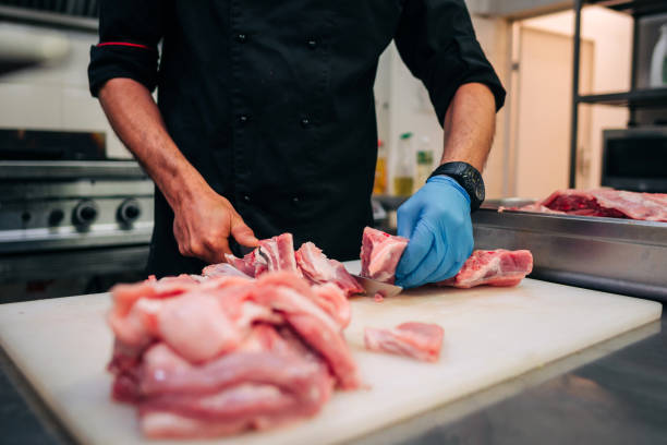 istock Male chef cutting raw pork ribs 1248327565