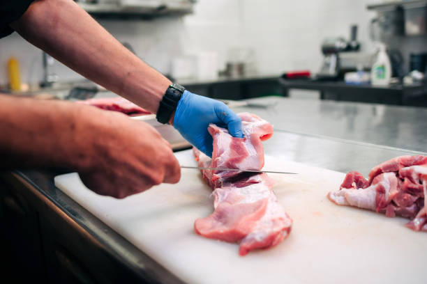 istock Male chef cutting raw pork ribs 1248327566