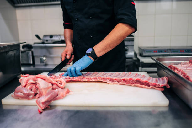istock Male chef cutting raw pork ribs 1248327568