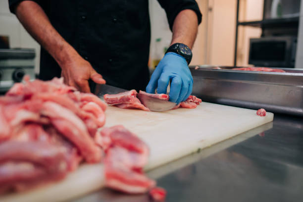 istock Male chef cutting raw pork ribs 1248327570