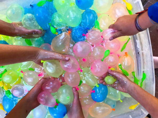 istock Children getting ready for a festive, summer water balloon fight. 1248328549