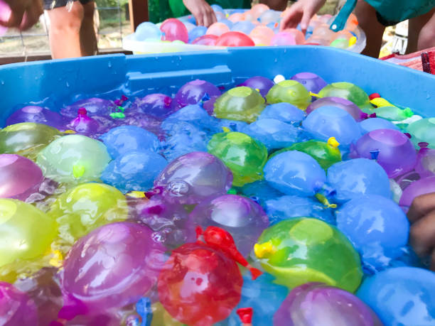 istock Children getting ready for a festive, summer water balloon fight. 1248328553