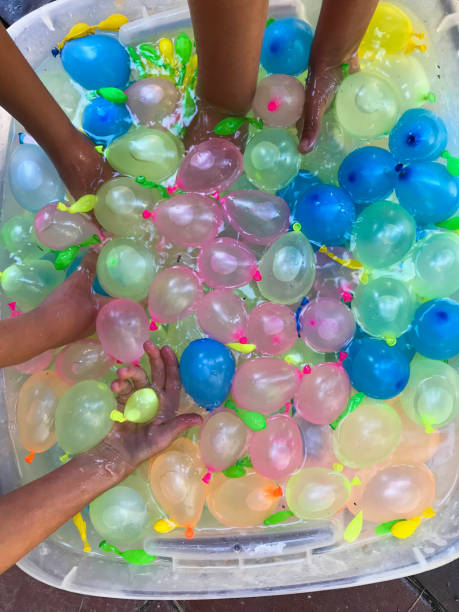 istock Children getting ready for a festive, summer water balloon fight. 1248328556