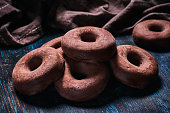 Close-up image of a doughnut like chocolate cookies. Old fashioned style on a bluish rustic table