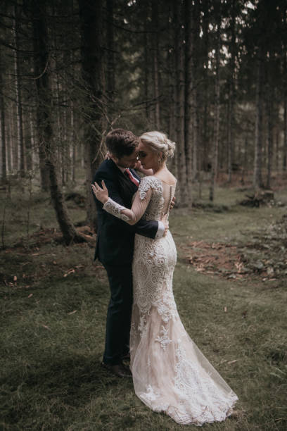 istock Very beautiful bride and groom having romantic time while wind blows wheats in the forest. 1248328852