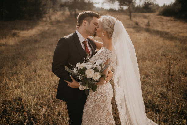istock Very beautiful bride and groom having romantic time while wind blows wheats in the forest. 1248328884