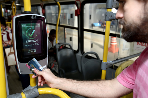 salvador, bahia / brazil - september 8, 2013: Passenger uses card to pay public transport fare when boarding public transport buses in the city of Salvador.