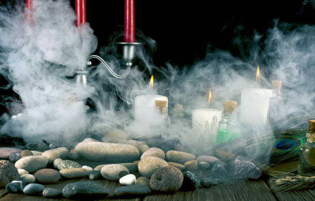 istock Magic potion, book, crystals, stones and candles with smoke 1248330904