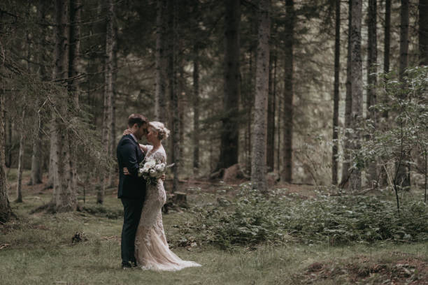 istock Very beautiful bride and groom having romantic time while wind blows wheats in the forest. 1248333168