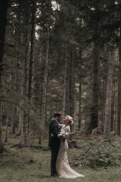 istock Very beautiful bride and groom having romantic time while wind blows wheats in the forest. 1248333216