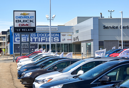 Montreal, Canada - April 4, 2020: Chevrolet Buick and GMC dealership with parking and cars on sunny day. They are most popular and recognizable automotive brands in the US.