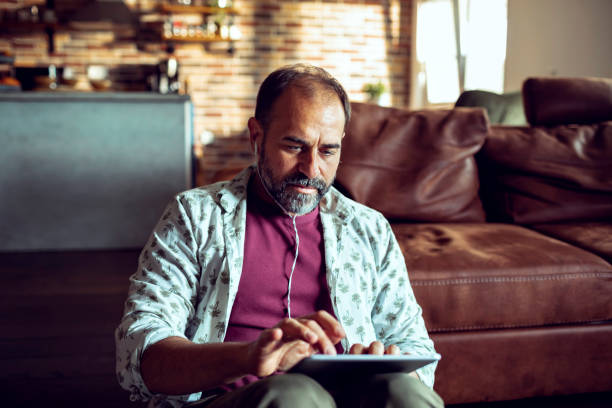 istock Adult using a tablet at home 1248349453