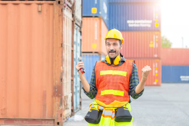 istock Engineer man in hard hat celebrating victory, foreman worker raise hands in celebration 1248359022