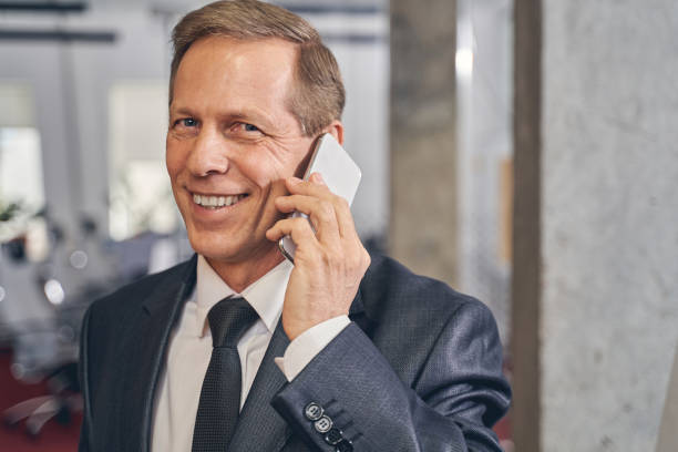 istock Kind elderly male being in business center 1248378062