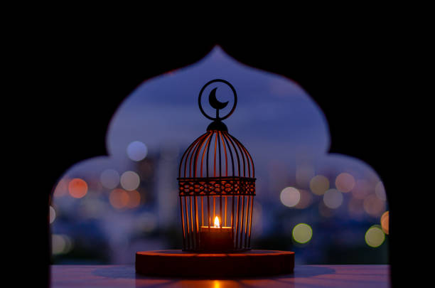 Lantern that have moon symbol on top with city bokeh light.