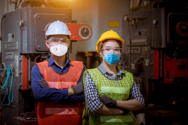 istock Portrait woman worker and engineer under inspection and checking production process on factory station by wearing safety mask to protect for pollution and virus in factory. 1248384559