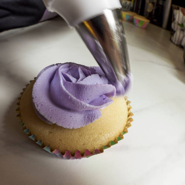 Decorating Homemade Ultra Violet Purple Mini Cupcake is