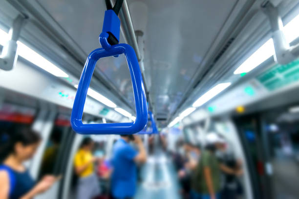 istock Passenger  hand holding onto a handle of a train on blur background. 1248384622