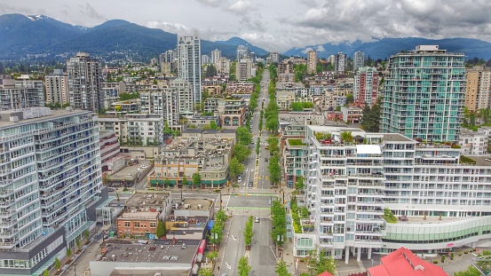 A drone shot of Lonsdale Avenue taken from a mavic mini. Grouse mountain, buildings, streets, and businesses.