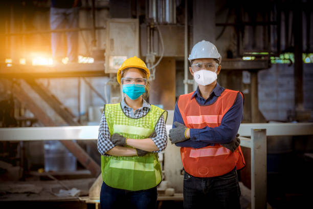 istock Portrait woman worker and engineer under inspection and checking production process on factory station by wearing safety mask to protect for pollution and virus in factory. 1248385765