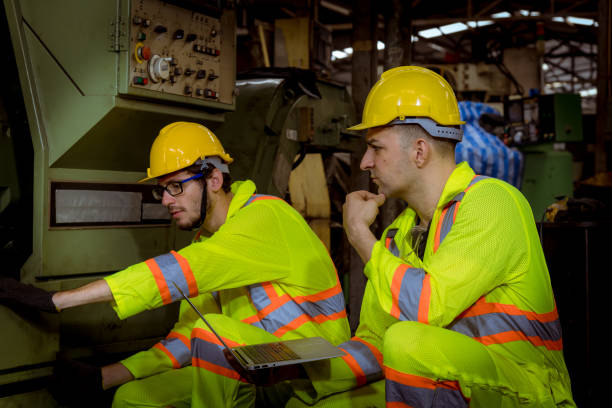 istock Engineer factory wear safety uniform working and discussion about work control machine in factory. 1248385822