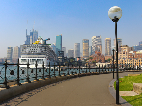 Australia, Sydney, October 31, 2019: Carnival Spirit cruise ship, railings and Sydney skyline from Hickson Road Reserve
