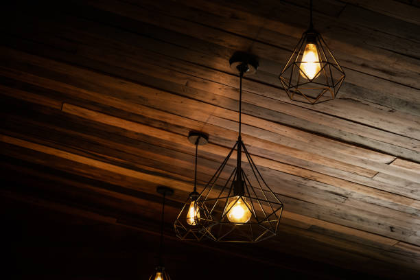 istock Beautiful vintage luxury light bulb hanging decor glowing in dark. 1248385957