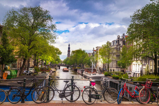 Amsterdam Canal Scene Bicycles on a bridge over a canal in Amsterdam jordaan amsterdam stock pictures, royalty-free photos & images