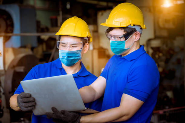 istock Portrait man worker under inspection and checking production process on factory station by wearing safety mask to protect for pollution and virus in factory. 1248388617