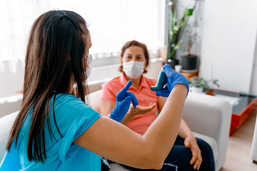 A female g.p. is telling her senior patient about her new medication