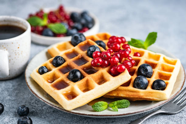 istock Belgian waffles with berries and cup of coffee 1248395189