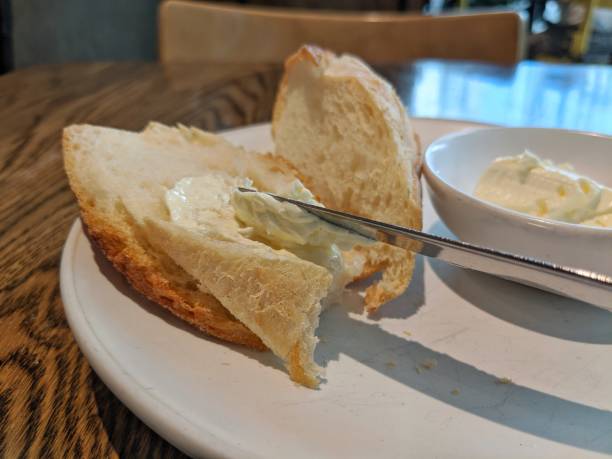 istock Spreading butter on bread with a knife. 1248400857