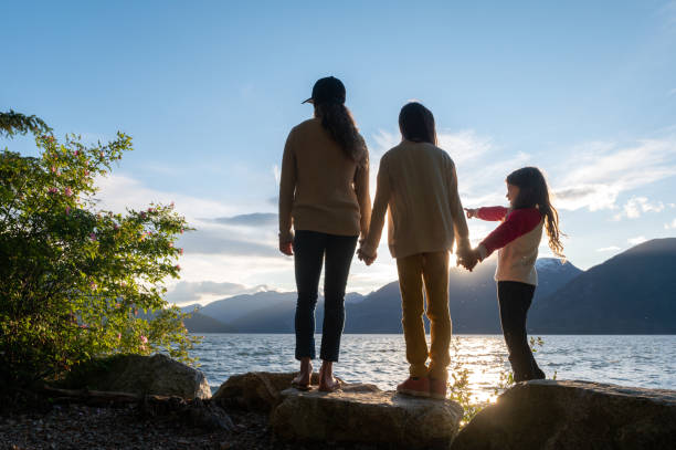 istock Mother and daughters bonding in nature 1248403231