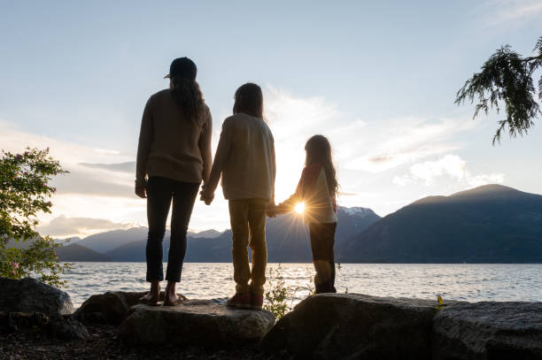 istock Mother and daughters bonding in nature 1248403232