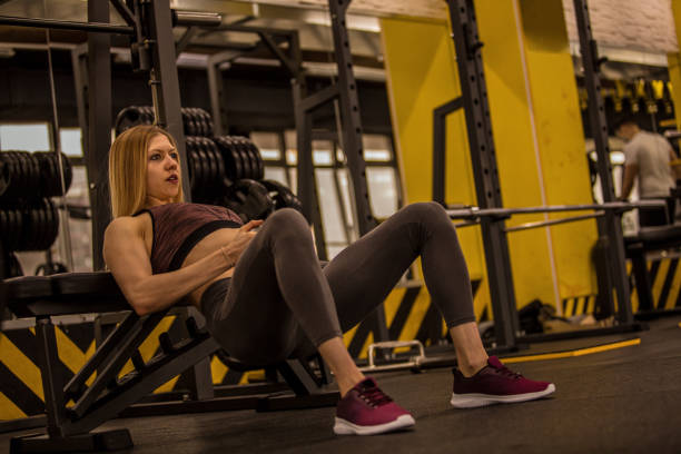 istock Copy space shot of athletic young woman doing bench hip thrusts with a kettlebell 1248406357