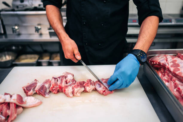 istock Male chef cutting raw pork ribs 1248406383