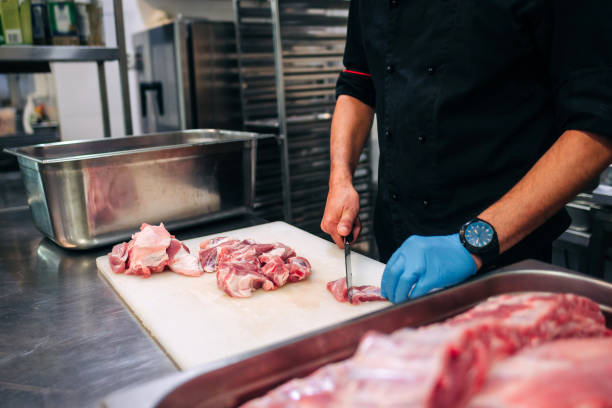 istock Male chef cutting raw pork ribs 1248406384