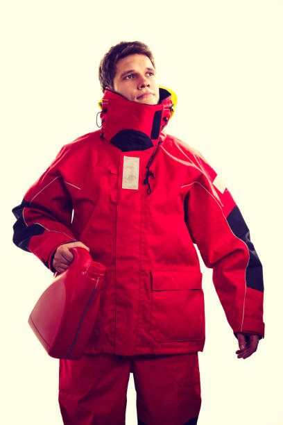 istock Man in oilskin with bottle. 1248413125