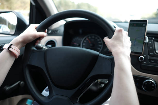 istock woman's hands holding steering wheel while driving a car 1248415548
