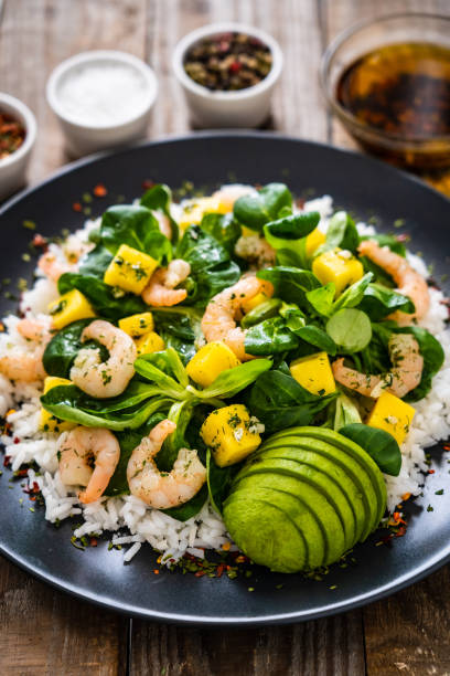 istock Prawns with vegetables on wooden table 1248417122