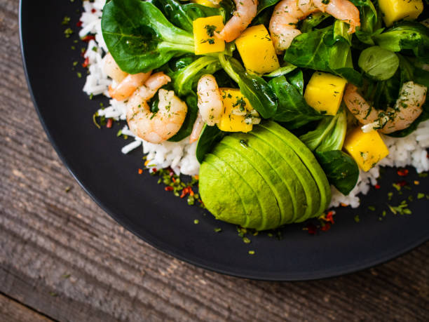 istock Prawns with vegetables on wooden table 1248417159