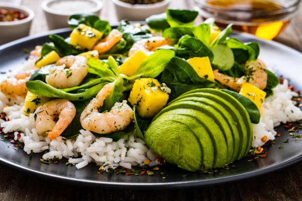 istock Prawns with vegetables on wooden table 1248417182