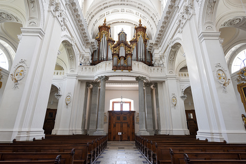 Inside view of the famous Solothurn Cathedral (Cathedral of St. Ursus). This huge church in Neoclasscal Style wasc completet in 1773. The Architects where Gaetano Matteo Pisoni and Paolo Antonio Pisoni. The image shows the church pipe organ and architectural columns.